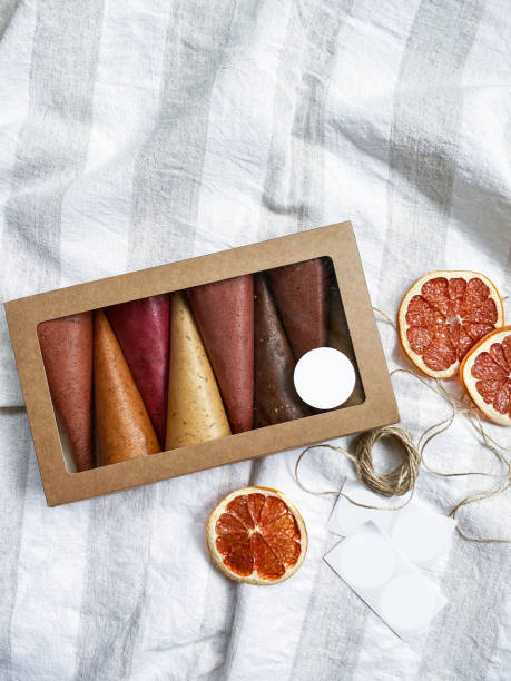 healthy sweets - fruit leather and fruit chips in box. sweet pure fruit pastille in rolls. natural sweets of berries and fruits. flat lay. close up - pastilles imagens e fotografias de stock