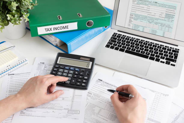 istock Accountant working with US tax forms 1303344181