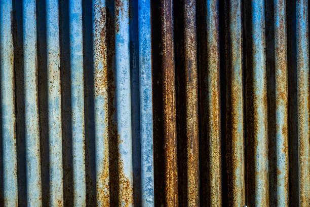 istock Rusted corrugated sheet metal siding background 1303345207