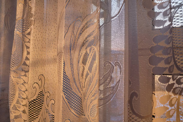 istock white tulle curtain with a pattern on on the window 1303345504