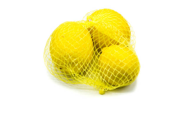 istock Lemons in the net isolated on white background 1303345525