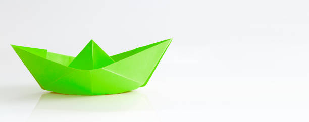 istock Paper boat isolated on white background 1303346877