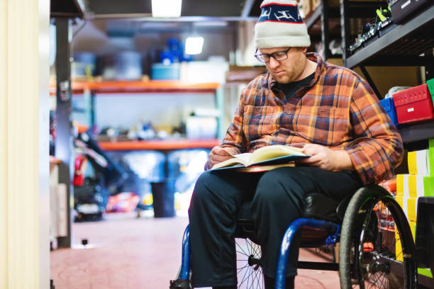istock Millennial Male College Student with Disability in Wheelchair Working and Studying at Work Photo Series 1303347883