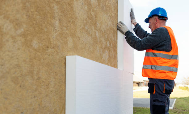 istock Construction worker placing styrofoam sheet insulation to the wall at construction site 1303347926