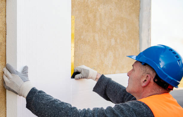 istock Construction worker placing styrofoam sheet insulation to the wall at construction site 1303347935