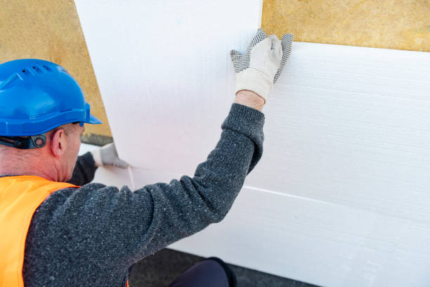 istock Construction worker placing styrofoam sheet insulation to the wall at construction site 1303347950