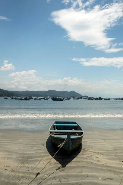 istock fishing boat on the beach with blue sky 1303348385