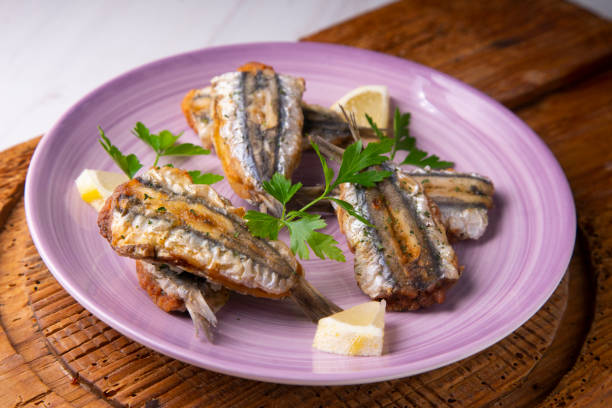 istock Traditional spanish tapa: Boquerones stuffed with malaga with parsley. 1303349348