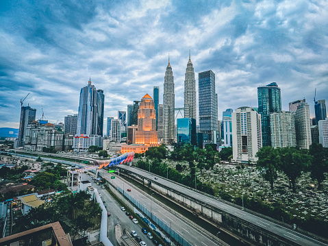 say time Kuala Lumpur Cityscape at day with bridge connection in between old town and new city buildings across highway