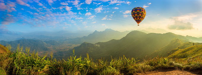 Colorful hot air balloons flying over mountain at Dot Inthanon in Chiang Mai, Thailand.