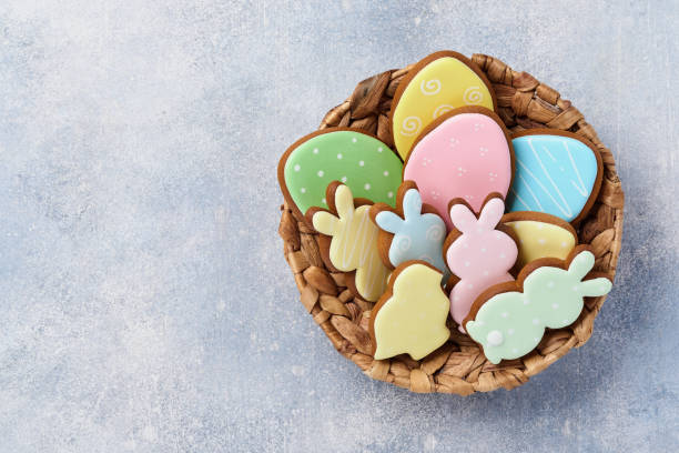istock Easter multicolored gingerbread, candy and scattered confectionery topping dressing on gray background. Easter baking background. Celebratory background concept. Space for text. 1303351689