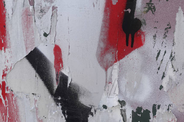 istock dirty spray painted glass surface with torn paper stains 1303356159