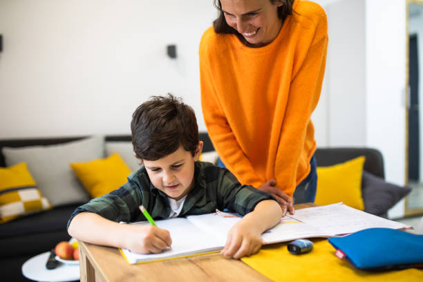 istock A caring mom helping her son with homework 1303357052