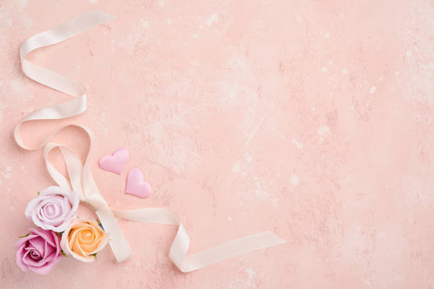 istock Festive composition with beautiful delicate roses flowers in pink round box on light pink background. Flat lay, copy space. Greeting card. 1303360808