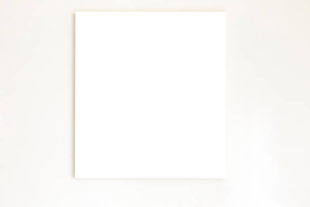 istock White canvas hanging on white wall, background with copy space 1303361916