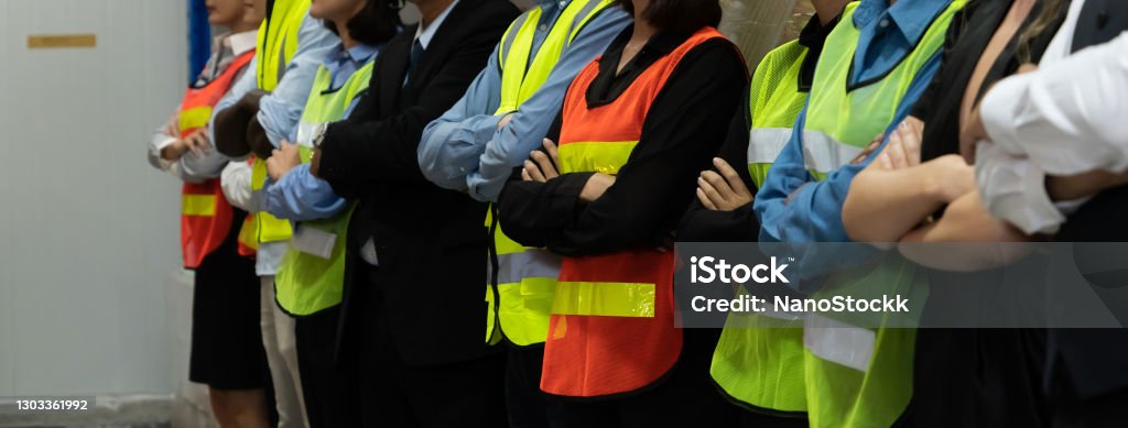 Large group of factory worker standing together in warehouse or storehouse Large group of factory worker standing together in warehouse or storehouse . Logistics , supply chain and warehouse business concept . Labor Union Stock Photo