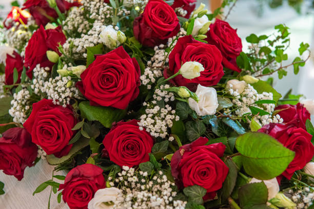 istock Flower arrangement with roses at a funeral.. 1303364009