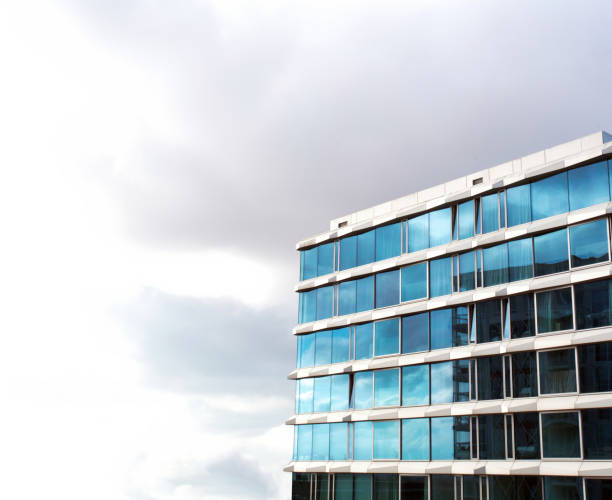 istock glass buildings,skyscraper with cloudy moody white sky background, Modern Office Building,modern architecture with copy space, business,abstract and design concept 1303365420