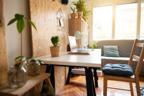 istock Close-up of a worktable in an empty home office apartment 1303366163