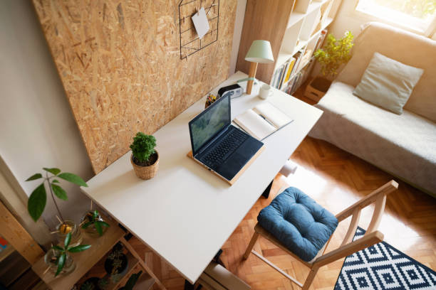 istock High angle view of a laptop and a notebook on a worktable in a modern apartment 1303366168
