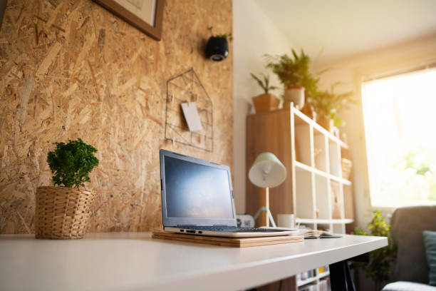 istock Laptop on a table in a cozy home office 1303366176
