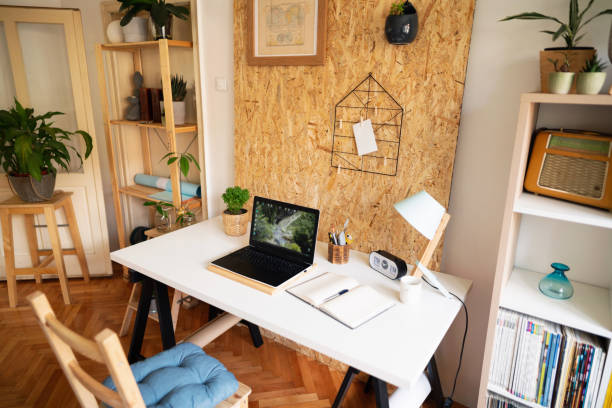 istock Laptop and a notebook on a modern design worktable in a home office 1303366177