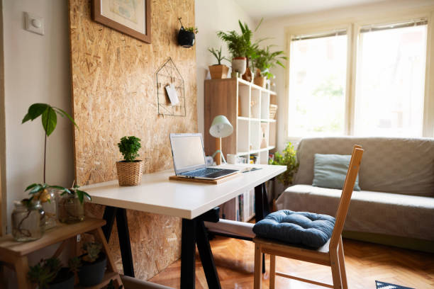 Creative workspace in cozy small apartment Creative workspace in cozy modern small apartment with worktable and household items. creative space photos stock pictures, royalty-free photos & images
