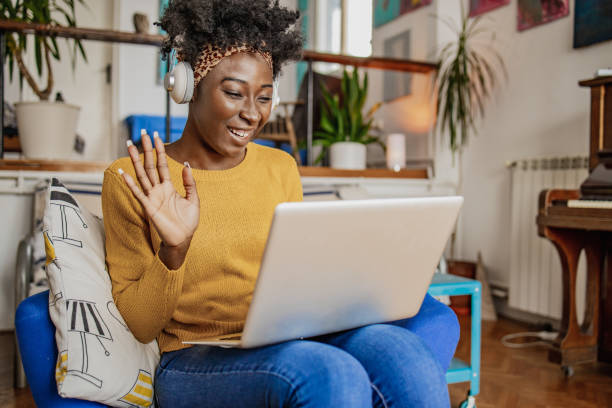 istock Young Woman is using laptop and communicating on a video call at home 1303366598