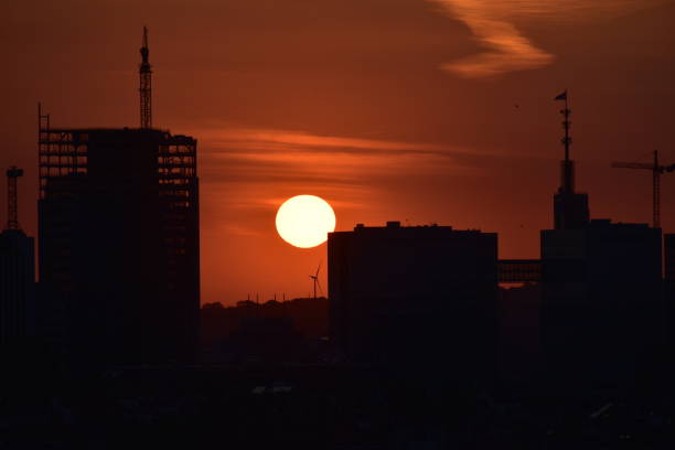 Silhouette of city center with construction on going and the  sun set
