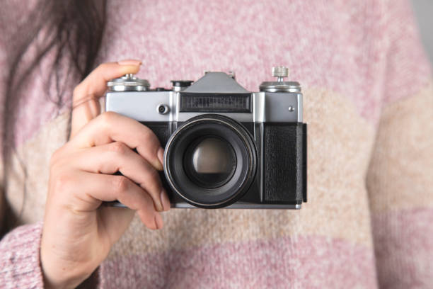 istock woman holding the vintage camera 1303368085