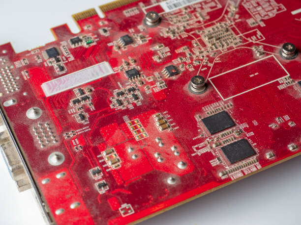 istock dusty printed circuit Board with red chips. Old video card 1303370179