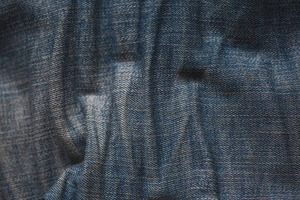 Close-up view of blue textured fabric featuring vertical ridged pattern for background or design