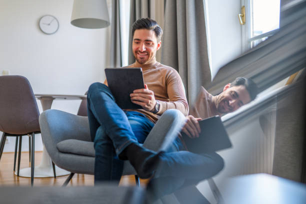 istock Caucasian Man Having Video Call and Using Digital Tablet at Home 1303372511