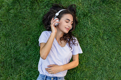 Photo of young woman relaxing and listening music