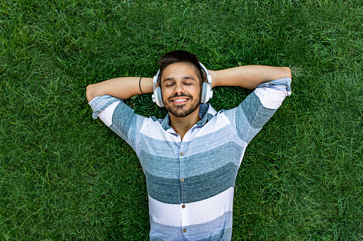 Photo of young man relaxing and listening music