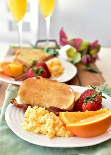 Tasty gourmet classic American style room service breakfast with bacon, hash browns, eggs, mimosas Fancy weekend breakfast for spring celebration, mother's day, birthday, breakfast in bed, new year's day. Photo concept, top view, copy space, food background breakfast room photos stock pictures, royalty-free photos & images