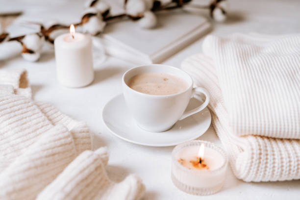 istock White cup of coffee, cotton, candles. 1303377078