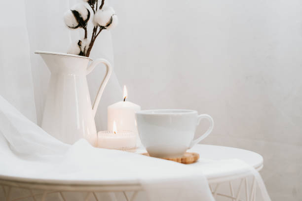 istock White cup of coffee, cotton, candles. 1303377440