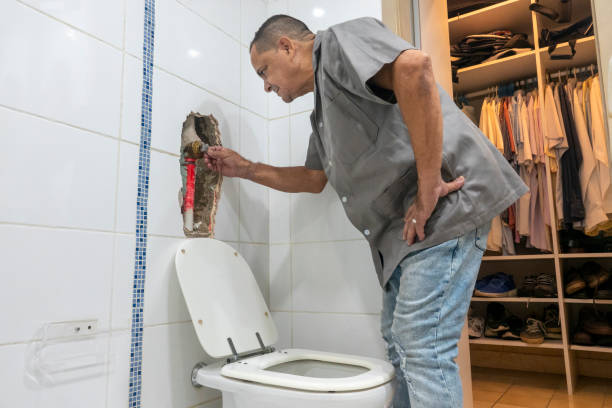 istock Man checking the toilet flush 1303378226