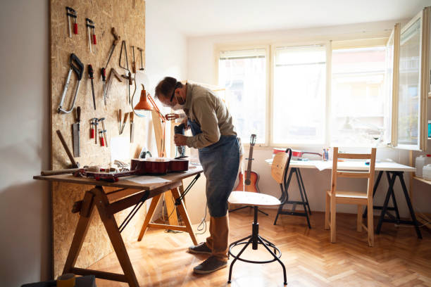istock Craftsman is sanding guitar in his guitar workshop 1303378558