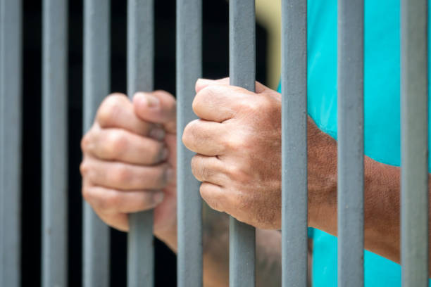 istock Hands of a man in prison 1303378618