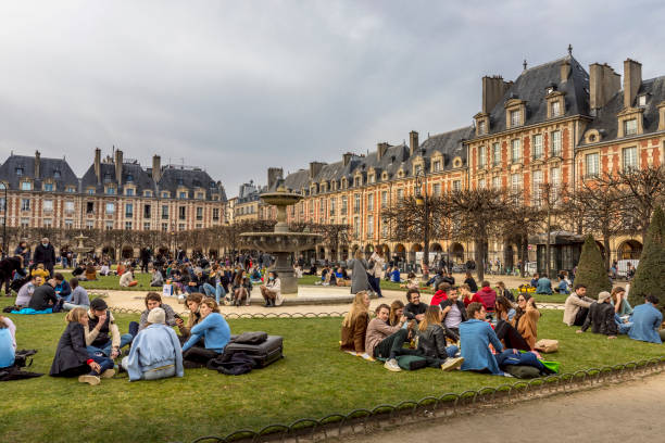 유명한 장소 데 vosges의 녹색 잔디밭에서 휴식을 취하는 사람들 - 파리에서 가장 오래된 계획 광장, covid-19 전염병 동안. - henry iv 뉴스 사진 이미지
