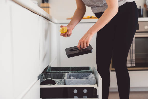 istock Kitchen drawer recycling bin - Woman hand throwing away organic waste 1303381164