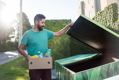 Man separating recyclable garbage, sustainability.