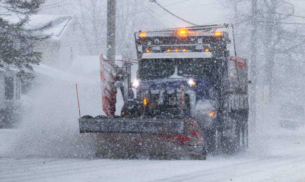 istock Municipal snowplow plowing road during snow storm 1303385257