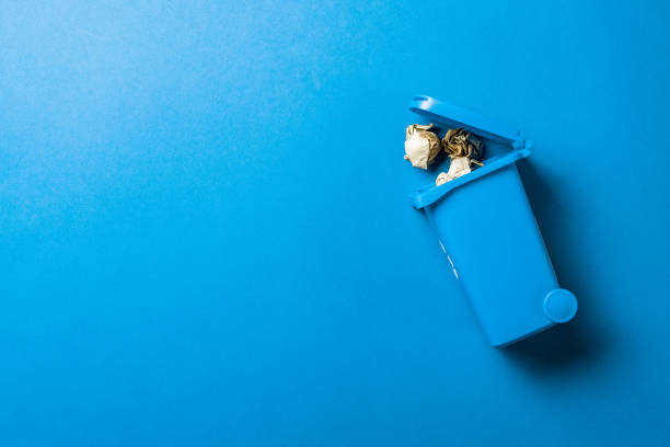 istock Recycle garbage. Blue dustbin for recycle paper trash isolated on blue background. Bin container for disposal garbage waste and save environment. 1303389593