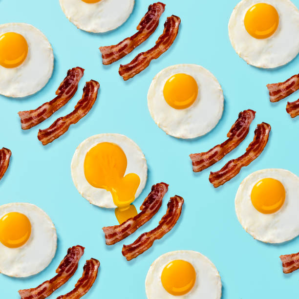 istock Bacon and Eggs Pop Art on a Bright Light Blue Background 1303390219