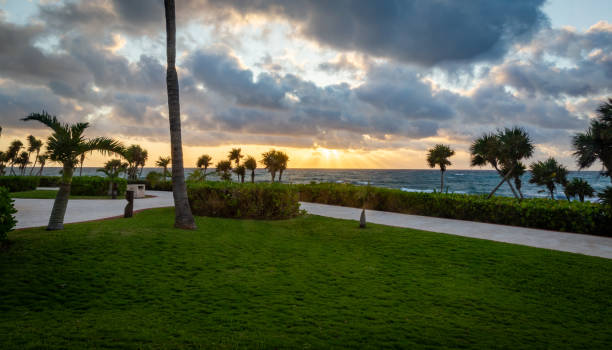 istock Sunrise over Caribbean Sea with well maintained lawn on the foreground 1303391237