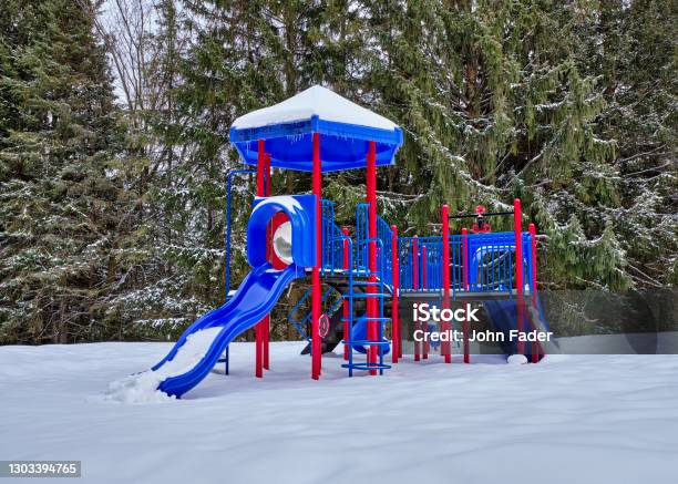 Colourful Playground Equipment Covered In Snow Stock Photo - Download Image Now - Blue, Bright, Built Structure