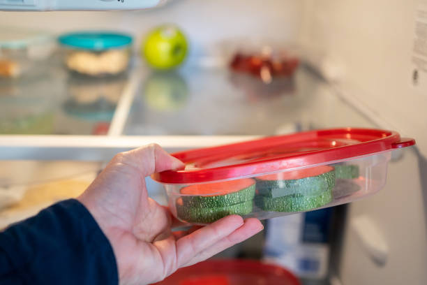 istock Person putting a plastic container on the refrigerator 1303395766